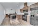 Bright kitchen features a stainless sink, modern black appliances, a breakfast bar, and wood cabinets at 5725 N Durango Dr, Las Vegas, NV 89149