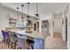 Kitchen island with seating overlooks the sink and stainless steel appliances at 5725 N Durango Dr, Las Vegas, NV 89149