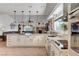 Modern kitchen with granite countertops and stainless steel appliances, flowing into the living room at 5725 N Durango Dr, Las Vegas, NV 89149