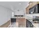 Charming kitchen featuring wood cabinets, granite countertops, stainless sink and black appliances at 5725 N Durango Dr, Las Vegas, NV 89149