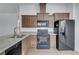 Updated kitchen featuring modern black appliances, granite countertops, and a stainless steel sink at 5725 N Durango Dr, Las Vegas, NV 89149