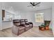 Open concept living room featuring reclining leather chairs, neutral walls, and natural lighting at 5725 N Durango Dr, Las Vegas, NV 89149