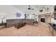 Comfortable living room with a large sectional sofa, decorative fireplace, and tile flooring at 5725 N Durango Dr, Las Vegas, NV 89149