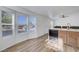 Bright living room featuring a stainless sink, modern black appliances, wood cabinets, and bay windows at 5725 N Durango Dr, Las Vegas, NV 89149