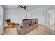 Bright living room features neutral walls, modern flooring, and comfortable seating under a ceiling fan at 5725 N Durango Dr, Las Vegas, NV 89149