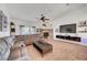 Comfortable living room featuring a fireplace, ceiling fan, and a large sectional sofa at 5725 N Durango Dr, Las Vegas, NV 89149