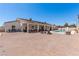 Spacious backyard featuring an expansive brick patio, pool, and covered seating areas at 60 N Fogg St, Las Vegas, NV 89110