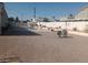 Spacious backyard with a patio, chairs, and a pool in the background at 60 N Fogg St, Las Vegas, NV 89110