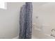 Clean bathroom with a shower/tub combination featuring a black and white shower curtain at 60 N Fogg St, Las Vegas, NV 89110