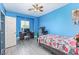 Bright blue bedroom with fan, computer desk, and plenty of room to play at 60 N Fogg St, Las Vegas, NV 89110