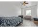 Simple bedroom featuring neutral colors, a ceiling fan, and a comfortable sofa at 60 N Fogg St, Las Vegas, NV 89110