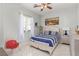 Cozy bedroom featuring a decorative bed frame, ceiling fan, and ample natural light at 60 N Fogg St, Las Vegas, NV 89110
