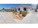 Spacious driveway with desert landscaping leads to a three-car garage at 60 N Fogg St, Las Vegas, NV 89110