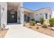 Welcoming entrance with decorative iron gate, desert landscaping, and stone accents at 60 N Fogg St, Las Vegas, NV 89110
