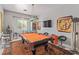 Game room with a classic pool table, unique lighting, and decorative art, perfect for entertaining guests at 60 N Fogg St, Las Vegas, NV 89110