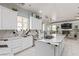 Bright kitchen featuring white cabinetry, island with cooktop, and marble countertops at 60 N Fogg St, Las Vegas, NV 89110