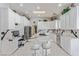 Spacious kitchen with white cabinets, cooktop island, stainless appliances, and marble flooring at 60 N Fogg St, Las Vegas, NV 89110