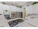 Modern kitchen featuring stainless steel appliances, white cabinets, and granite countertops at 60 N Fogg St, Las Vegas, NV 89110