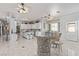 Open-concept kitchen and dining area featuring an eat-in island and elegant design, perfect for modern living at 60 N Fogg St, Las Vegas, NV 89110