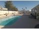 A private in-ground pool surrounded by a concrete deck in the backyard at 60 N Fogg St, Las Vegas, NV 89110