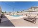 Beautiful backyard pool with a slide surrounded by ample patio space perfect for entertaining at 60 N Fogg St, Las Vegas, NV 89110