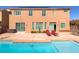 Backyard featuring a pool, patio seating, and a well-maintained lawn, creating a perfect outdoor oasis at 6403 Brandon Hills Ct, Las Vegas, NV 89139