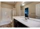 Bathroom featuring a tub and shower combination with a dark vanity and tile flooring at 6403 Brandon Hills Ct, Las Vegas, NV 89139