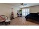 Bedroom with a ceiling fan, an adjacent desk, and a sliding glass door with plantation shutters at 6403 Brandon Hills Ct, Las Vegas, NV 89139