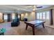 Expansive bonus room featuring an air hockey table, ceiling fans and natural light at 6403 Brandon Hills Ct, Las Vegas, NV 89139