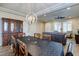 Spacious dining area connects to living room; features wood floors and modern lighting at 6403 Brandon Hills Ct, Las Vegas, NV 89139