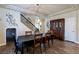Elegant dining room with a decorative chandelier, adjacent to the staircase and featuring stylish decor at 6403 Brandon Hills Ct, Las Vegas, NV 89139