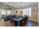 Bright dining room featuring wood-look flooring, plantation shutters, and modern lighting fixture at 6403 Brandon Hills Ct, Las Vegas, NV 89139
