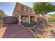 Beautiful two-story home with desert landscaping, a covered front porch, and a private gated driveway at 6403 Brandon Hills Ct, Las Vegas, NV 89139