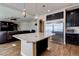 Spacious kitchen with island seating, stainless steel appliances, and open layout to living space at 6403 Brandon Hills Ct, Las Vegas, NV 89139