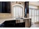 Kitchen with stainless steel sink and appliances, plus dark cabinets at 6403 Brandon Hills Ct, Las Vegas, NV 89139