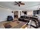 Open-concept living area flows to kitchen, with dark wood cabinets and modern appliances at 6403 Brandon Hills Ct, Las Vegas, NV 89139