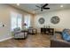 Comfortable living room with a ceiling fan, wood-look flooring, and stylish decor for a modern feel at 6403 Brandon Hills Ct, Las Vegas, NV 89139