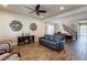 Spacious living and dining area with stylish decor, wood-look flooring, and an elegant staircase at 6403 Brandon Hills Ct, Las Vegas, NV 89139