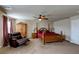 This carpeted main bedroom features a ceiling fan, wooden armoire, and leather chair at 6403 Brandon Hills Ct, Las Vegas, NV 89139
