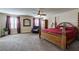This spacious main bedroom features a ceiling fan and two windows with burgundy curtains at 6403 Brandon Hills Ct, Las Vegas, NV 89139