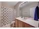 Bathroom featuring a single sink vanity, a large mirror, and a shower with a colorful curtain at 6437 Boatbill St, North Las Vegas, NV 89084