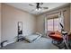Bedroom with comfortable seating, a large window, neutral walls, and a ceiling fan at 6437 Boatbill St, North Las Vegas, NV 89084
