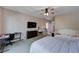Spacious bedroom featuring two beds, a ceiling fan, and ample space for a desk and dresser at 6437 Boatbill St, North Las Vegas, NV 89084