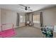 Bedroom with carpeted floors, two windows that let in natural light, and a ceiling fan at 6437 Boatbill St, North Las Vegas, NV 89084