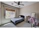 This bedroom is the perfect place to unwind and recharge with natural light and a ceiling fan at 6437 Boatbill St, North Las Vegas, NV 89084