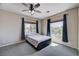 Bright bedroom featuring a ceiling fan and two windows with outside views at 6437 Boatbill St, North Las Vegas, NV 89084