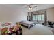 Bedroom featuring neutral carpet, ceiling fan, and natural lighting at 6437 Boatbill St, North Las Vegas, NV 89084