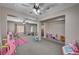 Spacious bonus room with neutral carpet, ceiling fan, and natural lighting at 6437 Boatbill St, North Las Vegas, NV 89084