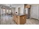 Kitchen featuring an island, stainless steel appliances, wood cabinets, and an eat-in area at 6437 Boatbill St, North Las Vegas, NV 89084
