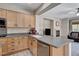 Kitchen featuring an island, wood cabinets, granite countertops, and stainless steel appliances at 6437 Boatbill St, North Las Vegas, NV 89084